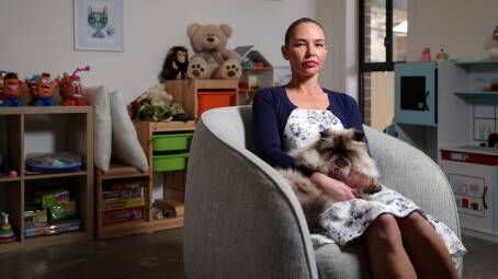 CONSTANT DEMAND: Psychologist Jaclyn Smoker sits in her Glenroy practice with Churchill the cat. "People are essentially putting off accessing the psychology services that they need and at the level of frequency that some of them actually need," she says. Picture: JAMES WILTSHIRE