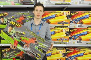 DANGER? Kmart general merchandise manager Stuart Morgan shows off one of the Nerf toy guns yesterday, which 16-year-old Anna Dore failed to get through security at Sydney Airport at the weekend. Picture: Addison Hamilton