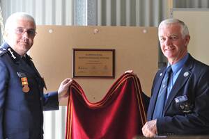 IT'S OFFICIAL: Operations manager of south region Superintendent Nick Turner (left) and Councillor Alan Brown unveil the plaque to open the new building for the Riverina Zone Aviation Brigade at Wagga Airport.