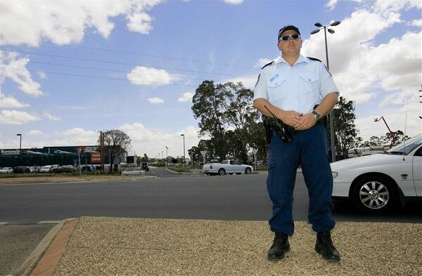 CAR CONFUSION: Senior Constable Watson at the roundabout located on Pearson Street at the entrance to the new Bunnings store. Confusion has surrounded how motorists are supposed to indicate on the roundabout with the store’s entrance adjacent to the Pearson Street exit.  Picture: Addison Hamilton