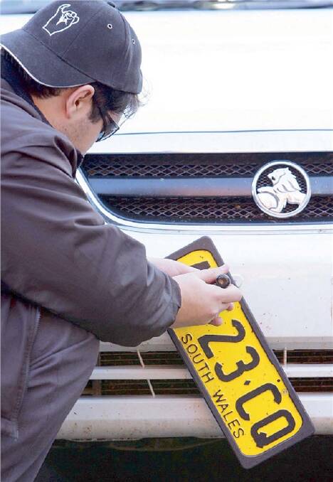 PLATE SPATE: A spate of number plate thefts, as seen in this re-enactment, have occurred in parts of Wagga recently.