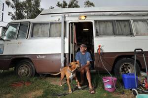 HIT THE ROAD: Tony Maloni has been camping at Wilks Park in his Toyota Coaster for a week with his dog Whoppy. He plans to stay another 10 days before he moves on. He doesn’t think it is affordable to pay $80 a week for a site at caravan park. Picture: Oscar Colman