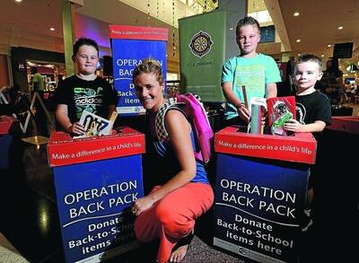 MISSION POSSIBLE: Reality television star and Marketplace ambassador Katrina Chambers launches Operation Backpack. She is with her three children (from left) Tex, 6, Cruise, 9, and Chevy, 5. Picture: Addison Hamilton