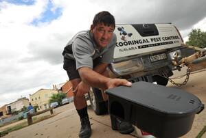 PEST CONTROL: Pest controller Glenn Lawson refills a rodent bait trap at a Wagga business. Picture: Michael Frogley.