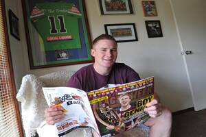 READY TO SOAR: Nick Skinner admires a Manly NRL premiership poster at his Wagga home yesterday. Skinner has just signed to play with the Sea Eagles for the next two years. Picture: Les Smith