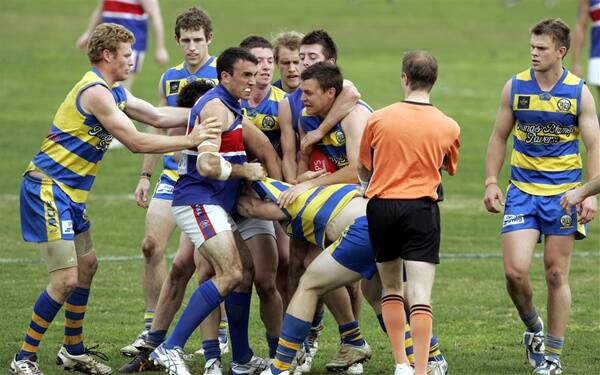 TEMPERS FLARE: Players from both Mangoplah-Cookardinia United-Eastlakes and Turvey Park sort each other out in yesterday's Riverina Football League preliminary final at Narrandera Sports Ground.