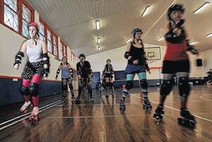 FREE WHEELING: Skater Katie Freeland (left) trains with Wagga’s other aspiring roller derby damsels at the PCYC on Sunday.  	Pictures:  Oscar Colman