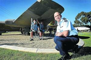 FACE LIFT: The two aircraft that guard the RAAF Base in Forest Hill, Canberra and Mirage, are currently being refurbished. Group Captain Tony Checker (front) expects Jamie Hurst, Laurie Jones and Garry Austin of Douglas Aerospace to have them looking shiny and new by mid-May. Picture: Oscar Colman