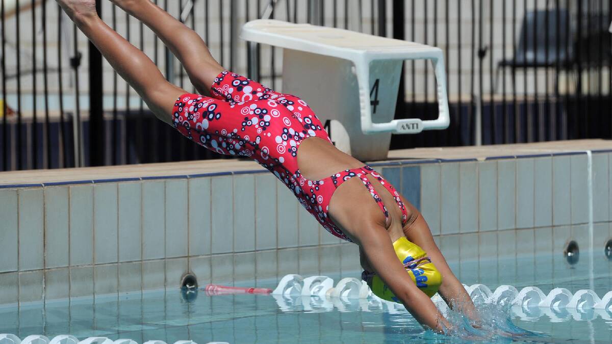 Meg Senior, 9, dives in for her 50m freestyle. Picture: Michael Frogley