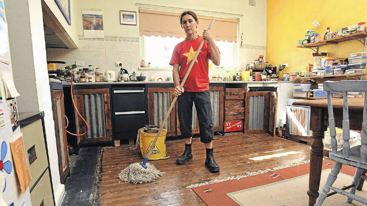 NOT OVER: North Wagga resident Michelle Crocker stands in her Henry Street house yesterday, nearly 12-months after floods ravaged the suburb. Picture: Les Smith 