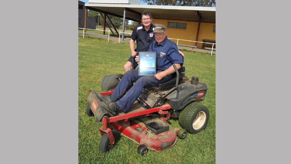 Ken Reynolds at Gumly oval with his AFL merit award is pictured with Paul Habel (left). Picture: Les Smith