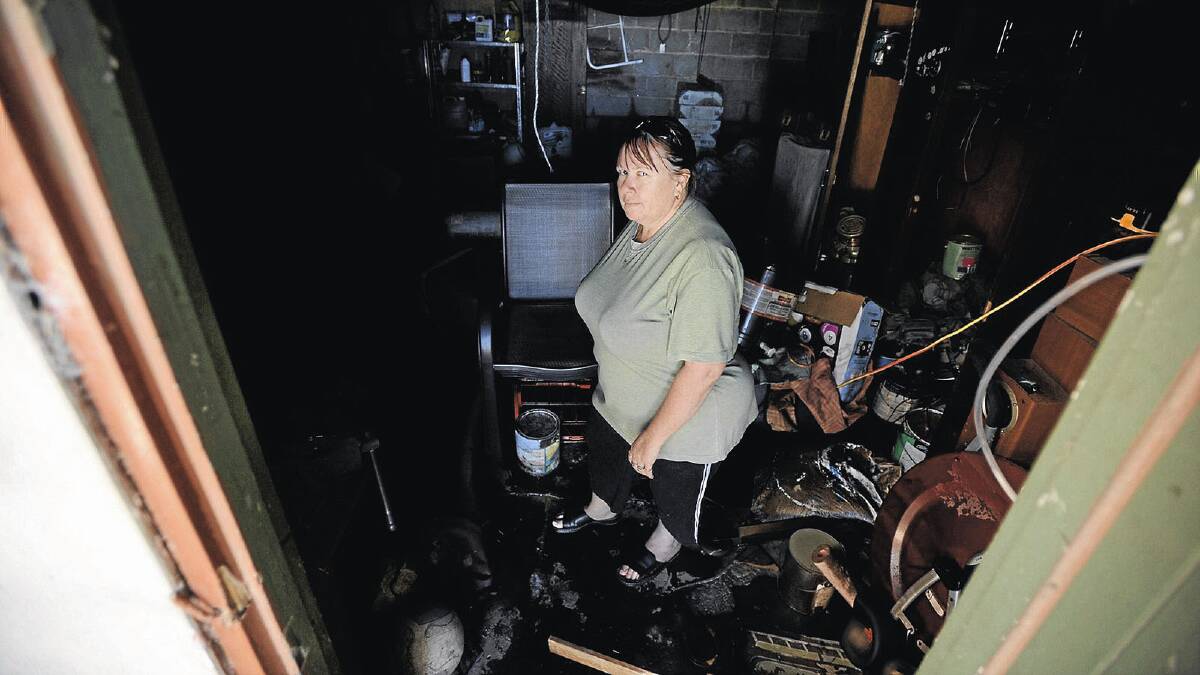 DAMAGE: North Wagga resident Marree Bruce stands in the shed of her Gardiner Street home after it was flooded last year. Picture: Addison Hamilton