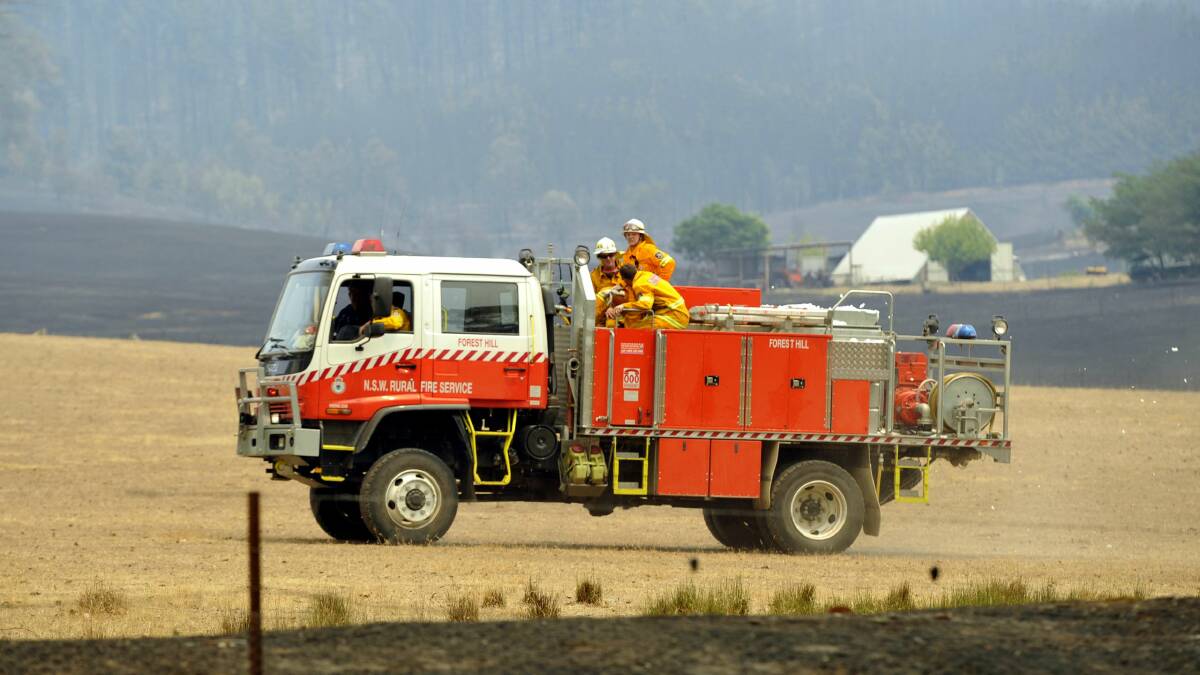 Firefighters tackling the Minnimbah fire on Sunday. Picture: Les Smith