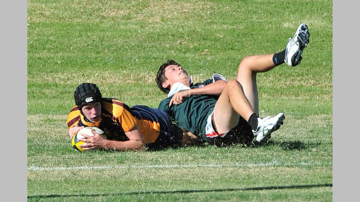 SIRU 10s ... Mater Dei's Nick Murphy goes in for a try despite the efforts of TRAC's Theo Metcalfe. Picture: Michael Frogley