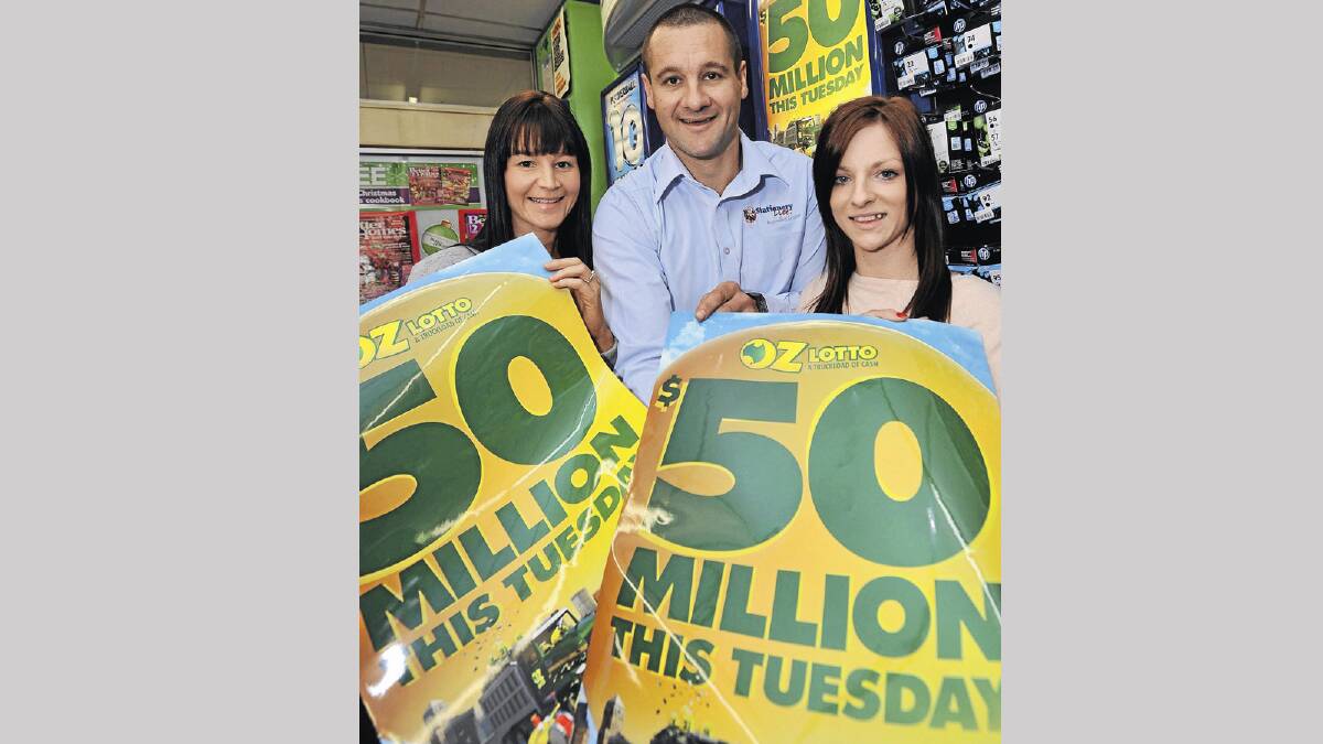 JACKPOT: (From left) Kooringal Newsagency managers Rachelle and Geoff Seymour and Samara Donaldson hold up signs for the $50 million Oz Lotto jackpot ahead of tonight’s draw. Picture: Michael Frogley
