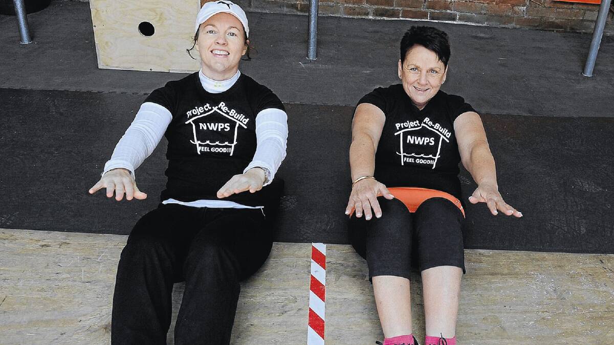 WORKING HARD: Nicky Rogers (left) and Rhonda Thomson take part in the second round of CrossFit2650’s Project Rebuild, Feel Good competition. Picture: Michael Frogley