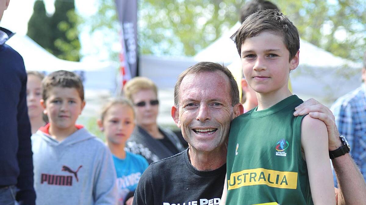 WELL DONE: Opposition Leader Tony Abbott and Mitchell Foster, 10, after they competed in the Lake To Lagoon fun run in Wagga yesterday. Picture: Oscar Colman
