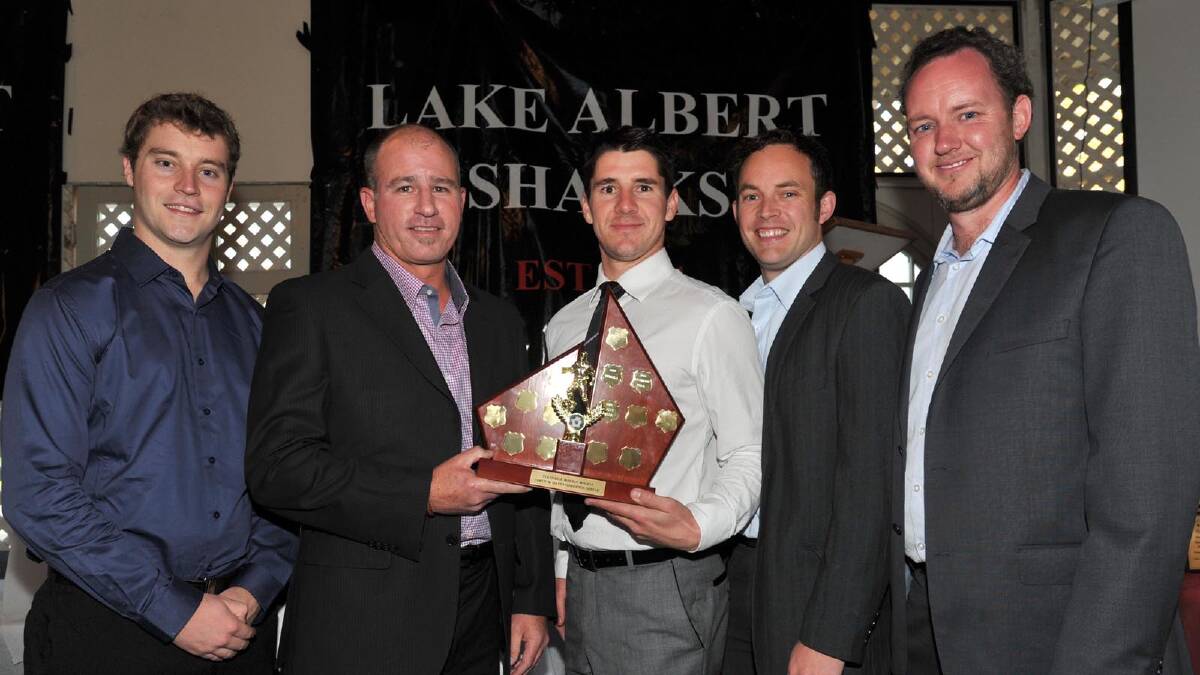 GREAT NIGHT (right): Nathan Hart, Anthony Gardiner, Chris Turner, Hayden Callander and Lake Albert president Erwin Budde show off the second grade premiership trophy at the annual presentation night on Saturday. Pictures: Les Smith