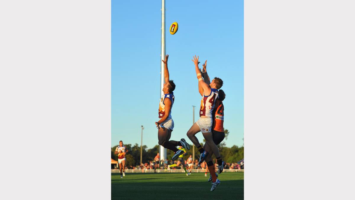 GWS v Brisbane at Robertson Oval - Brisbane players Rohan Bewick and Aaron Cornelius with GWS Jonathan Giles in a marking contest. Picture: Addison Hamilton