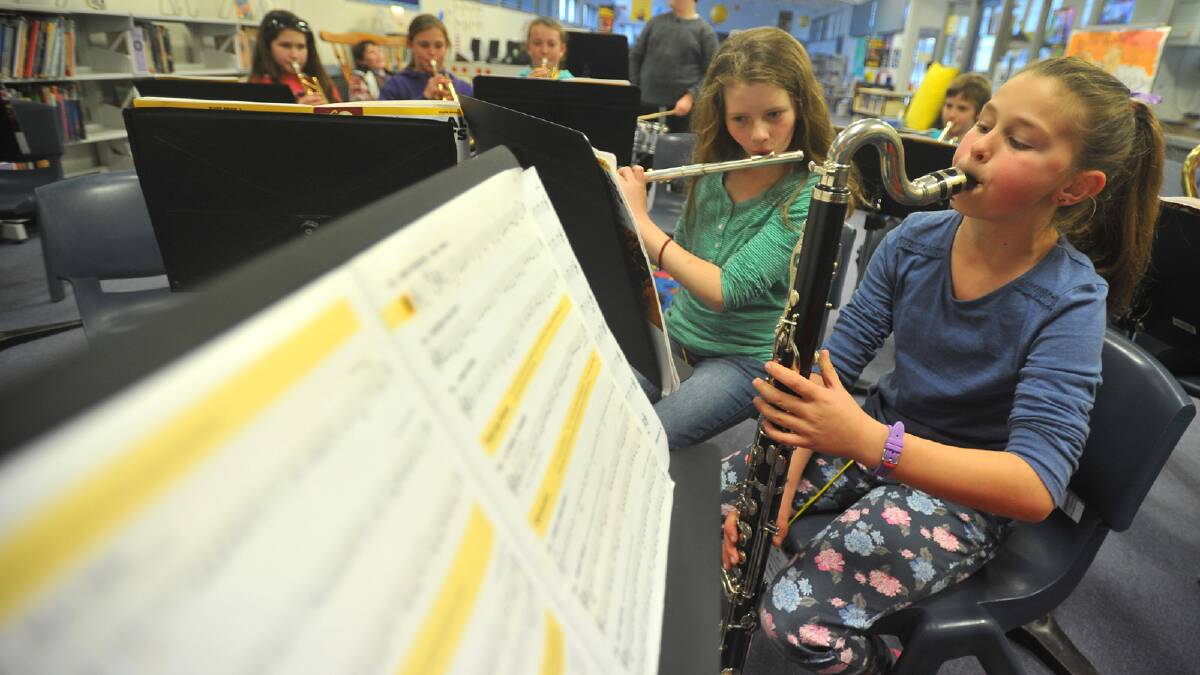 Kooringal Public School band members Grace Stein, 12, on the flute and Isabella Stephens, 11, on the bass clarinet during a weekend sleepover at the school. Picture: Addison Hamilton 