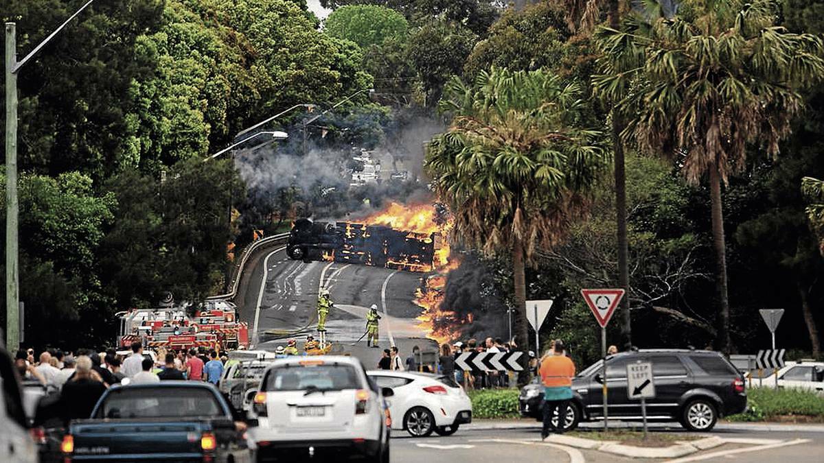 FIERY CRASH: The scene of Tuesday’s accident near Mona Vale. The driver, a Wagga man, desperately tried to warn others that his petrol tanker was out of control.