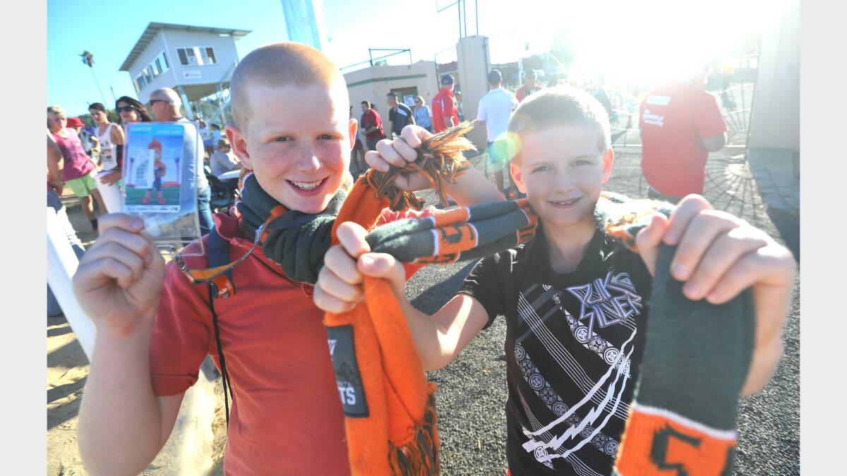 GWS v Brisbane at Robertson Oval - Frankie Allen (10) and Morris Benjamin (8) show their support for GWS. Picture: Addison Hamilton