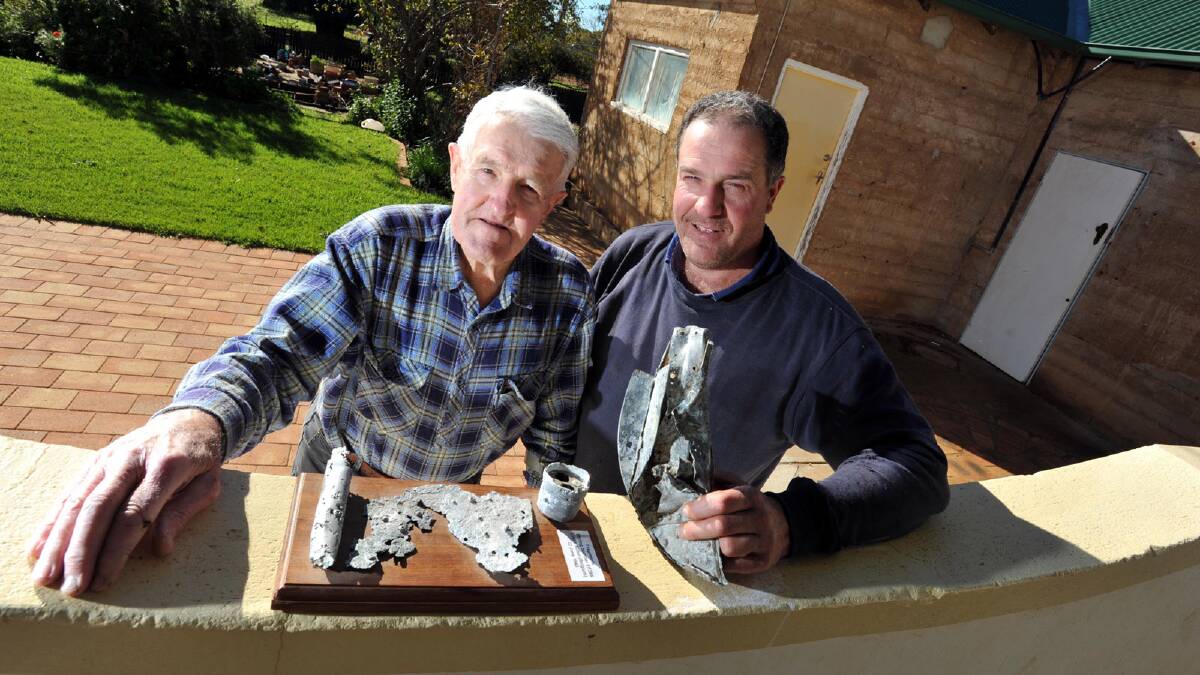 REMEMBERED: Peter (left) and David Meiklejohn at the famliy’s Downside property, with parts of Bruce’s bomber that crashed in Belgium in 1943.