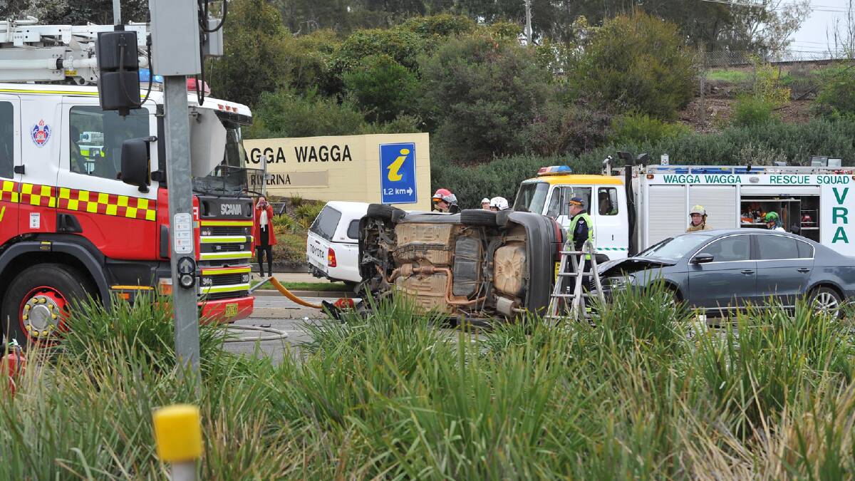 A car truned on its side after colliding with a truck, traffic light and a parked car at the Tarcutta Street railway on Monday. Picture: Michael Frogley