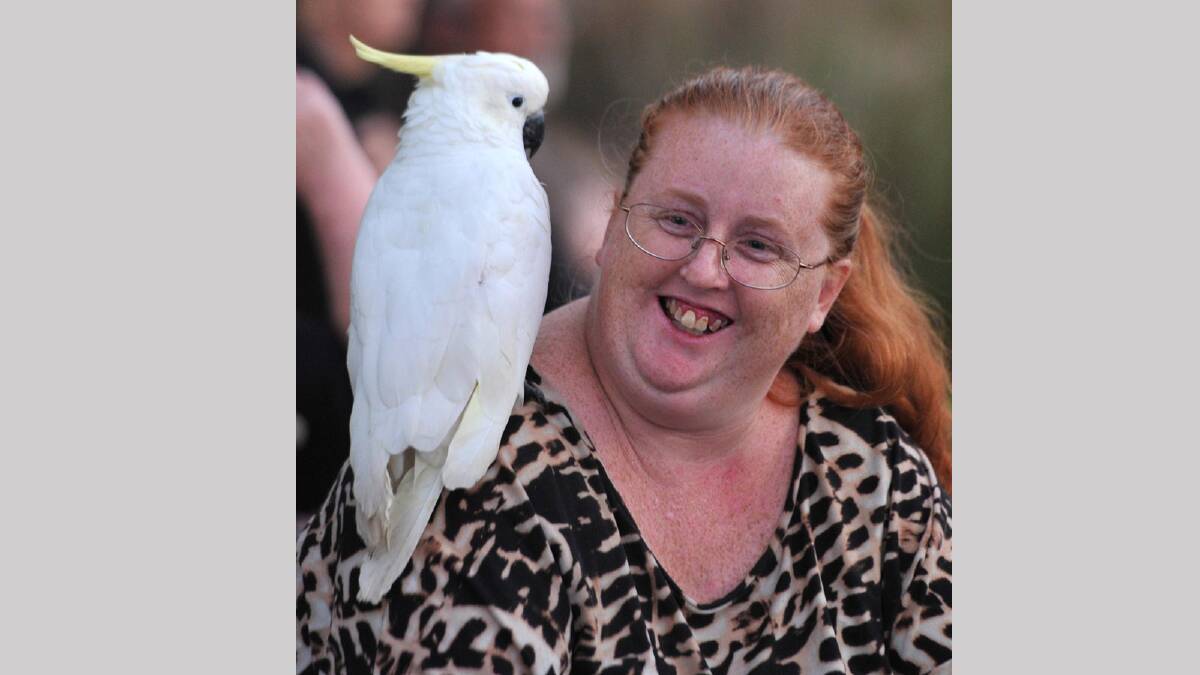 Vicky Herbert from Coolamon with Purdy the cockatoo at Twlight by the Lagoon. Picture: Les Smith