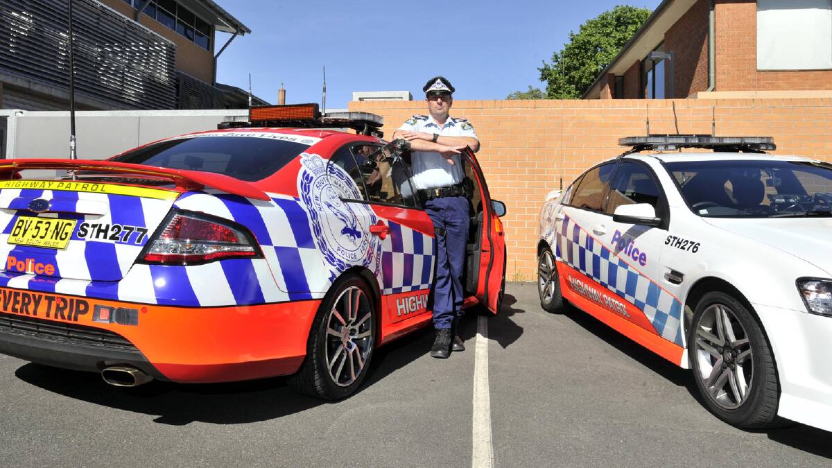 Wagga Highway Patrol supervisor Sergeant John Aichinger stands between the two new high visibility vehicles. Picture: Les Smith
