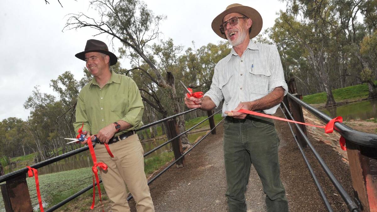 Project managers Peter Beal and Terry Smith cut the ribbon to open the Rocky Waterholes Bridge as part of Narrandera's sesquicentenary celebrations. Picture: Les Smith