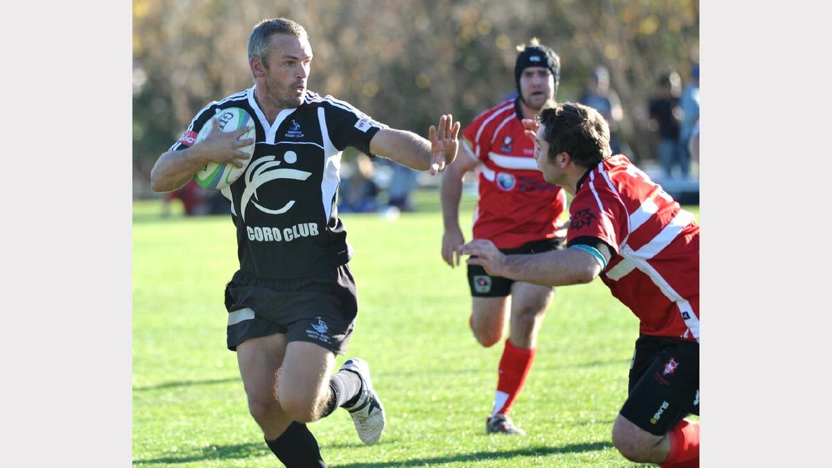 Griffith scrumhalf Aaron Lawrence looks to fend away CSU's Te'eo Kaue. Picture: Les Smith