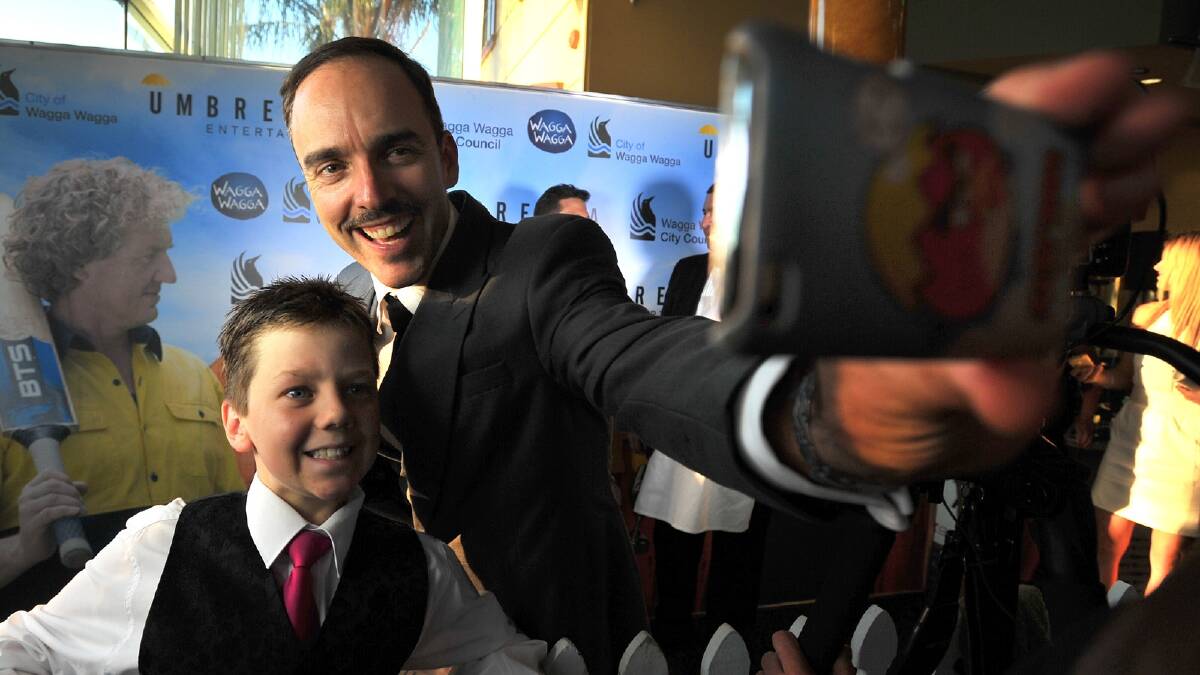 Backyard Ashes world premiere - Dylan Trevaskis, 11, gets a photo with lead actor Felix Williamson. Picture: Addison Hamilton